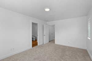 Unfurnished bedroom with carpet floors and a textured ceiling