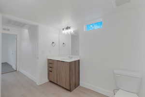 Bathroom with vanity and light wood-style floors
