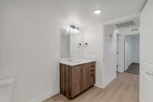 Bathroom with vanity and light wood finished floors