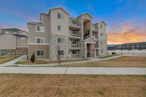Property at dusk with a view of apartment building / complex