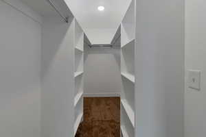 Walk in closet with dark colored carpet