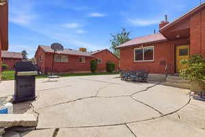 View of patio with outdoor dining space and grilling area