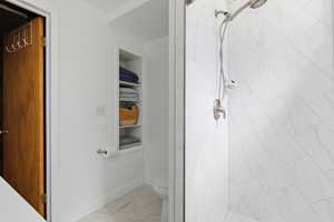 Full bath with a stall shower and light tile patterned flooring