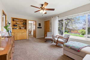 Sitting room with carpet floors and a ceiling fan