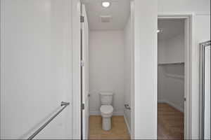 Bathroom with toilet and light tile patterned floors