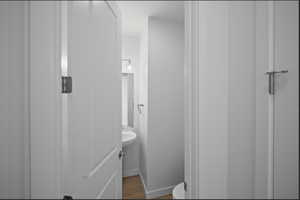 Bathroom with baseboards and wood finished floors