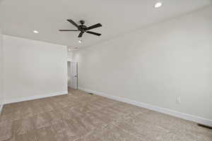 Carpeted spare room with recessed lighting and a ceiling fan