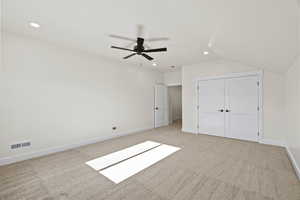 Unfurnished bedroom with recessed lighting, light colored carpet, ceiling fan, and lofted ceiling