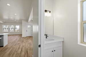 Bathroom featuring vanity, recessed lighting, and light wood-style flooring