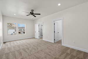 Unfurnished bedroom featuring light colored carpet, a ceiling fan, and recessed lighting