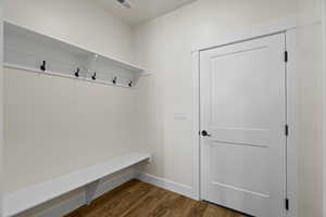 Mudroom with wood finished floors and baseboards
