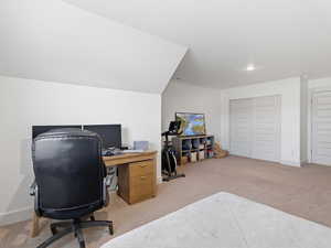 Office space with light colored carpet and baseboards