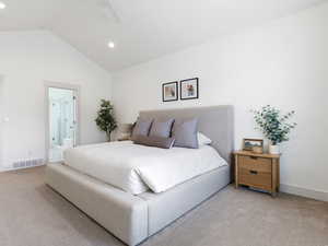 Bedroom featuring light carpet, ceiling fan, lofted ceiling, ensuite bath, and recessed lighting