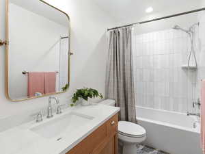 Bathroom with vanity and shower / tub combo with curtain