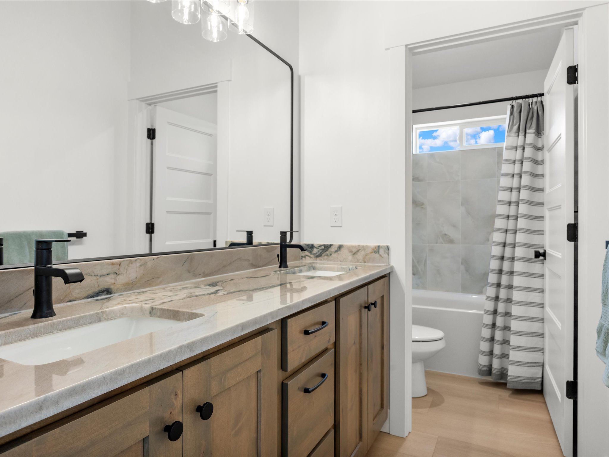 Bathroom featuring a double vanity with stone countertops and undermount sinks
