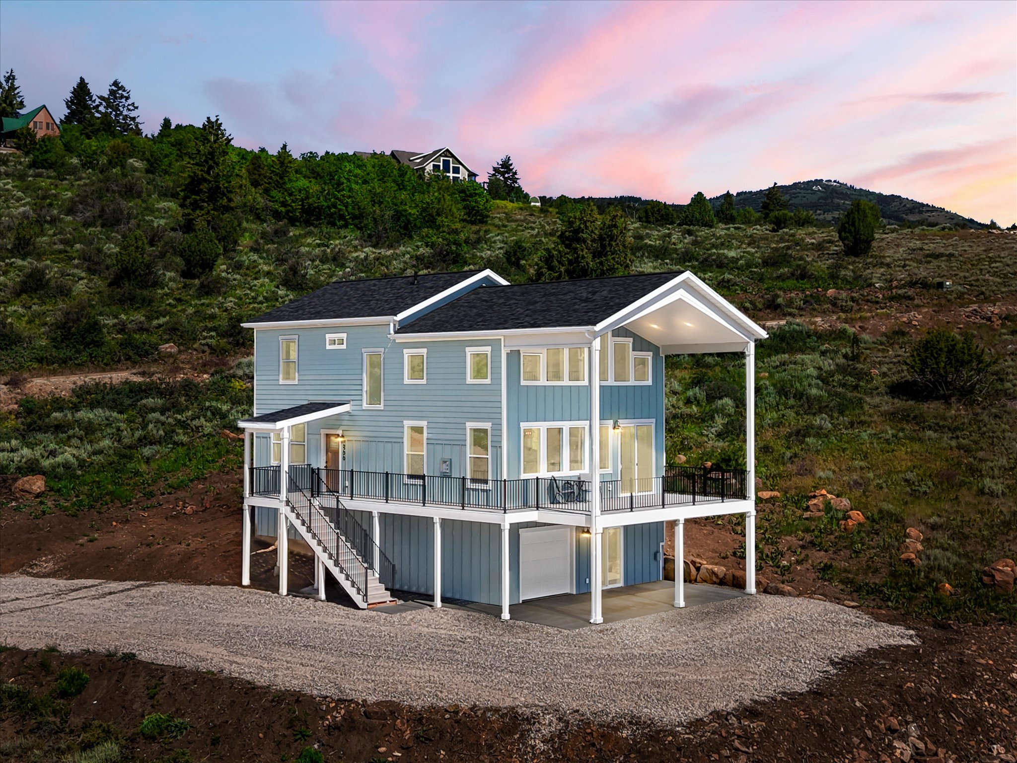 Modern light blue siding exterior with a dark shingled roof