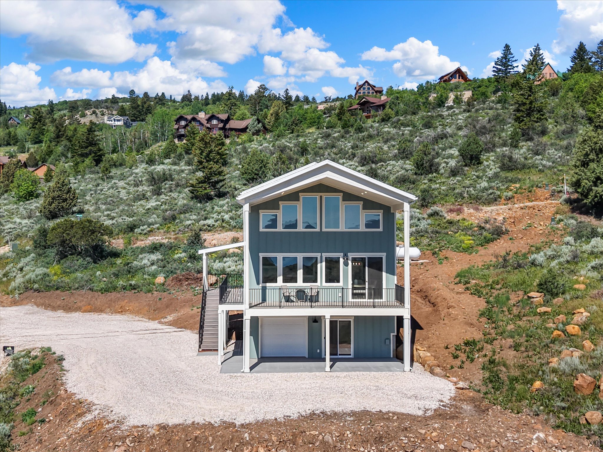 Contemporary exterior featuring blue siding with white trim