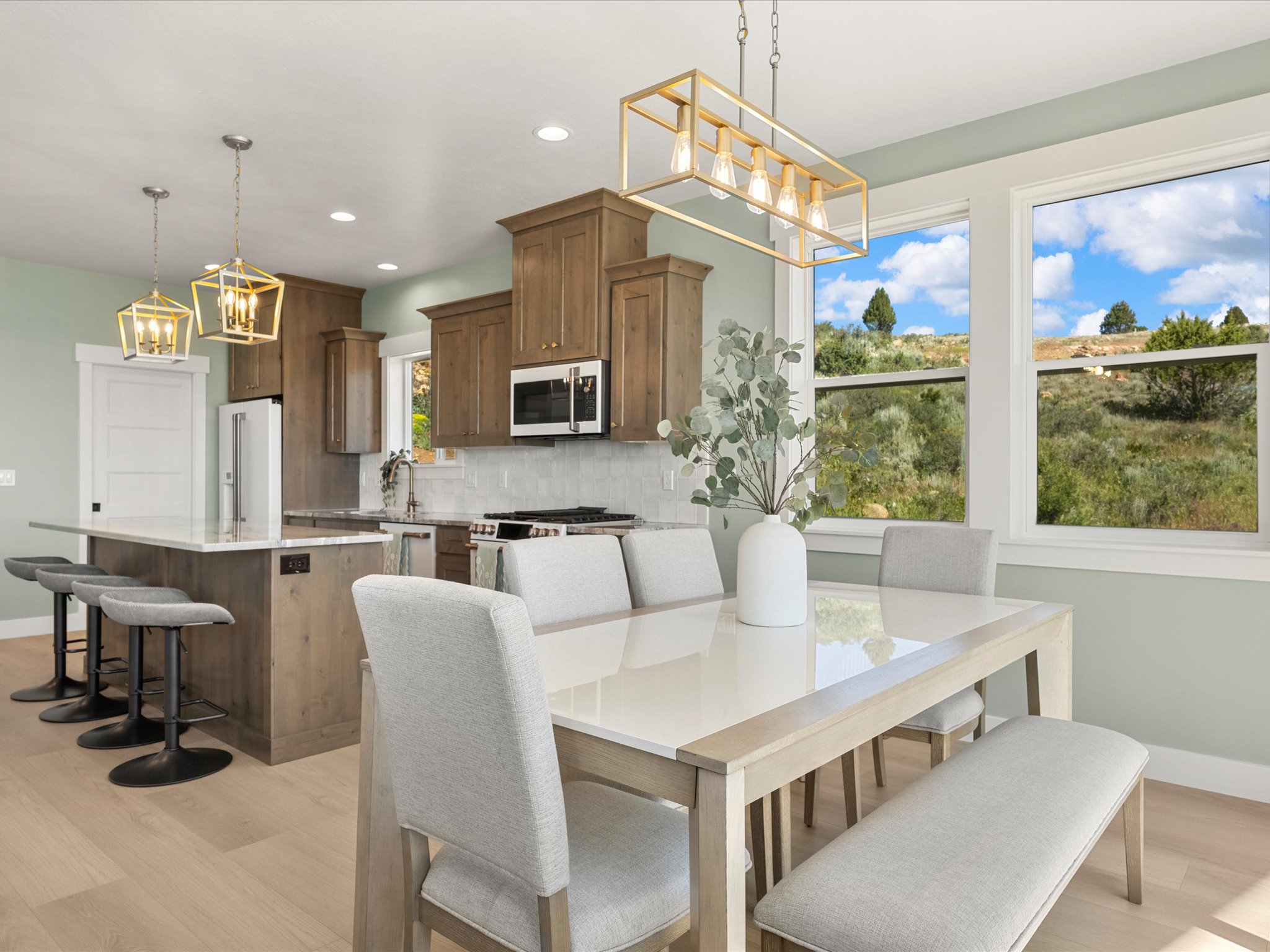 Open-concept kitchen and dining area featuring wood-finish flooring