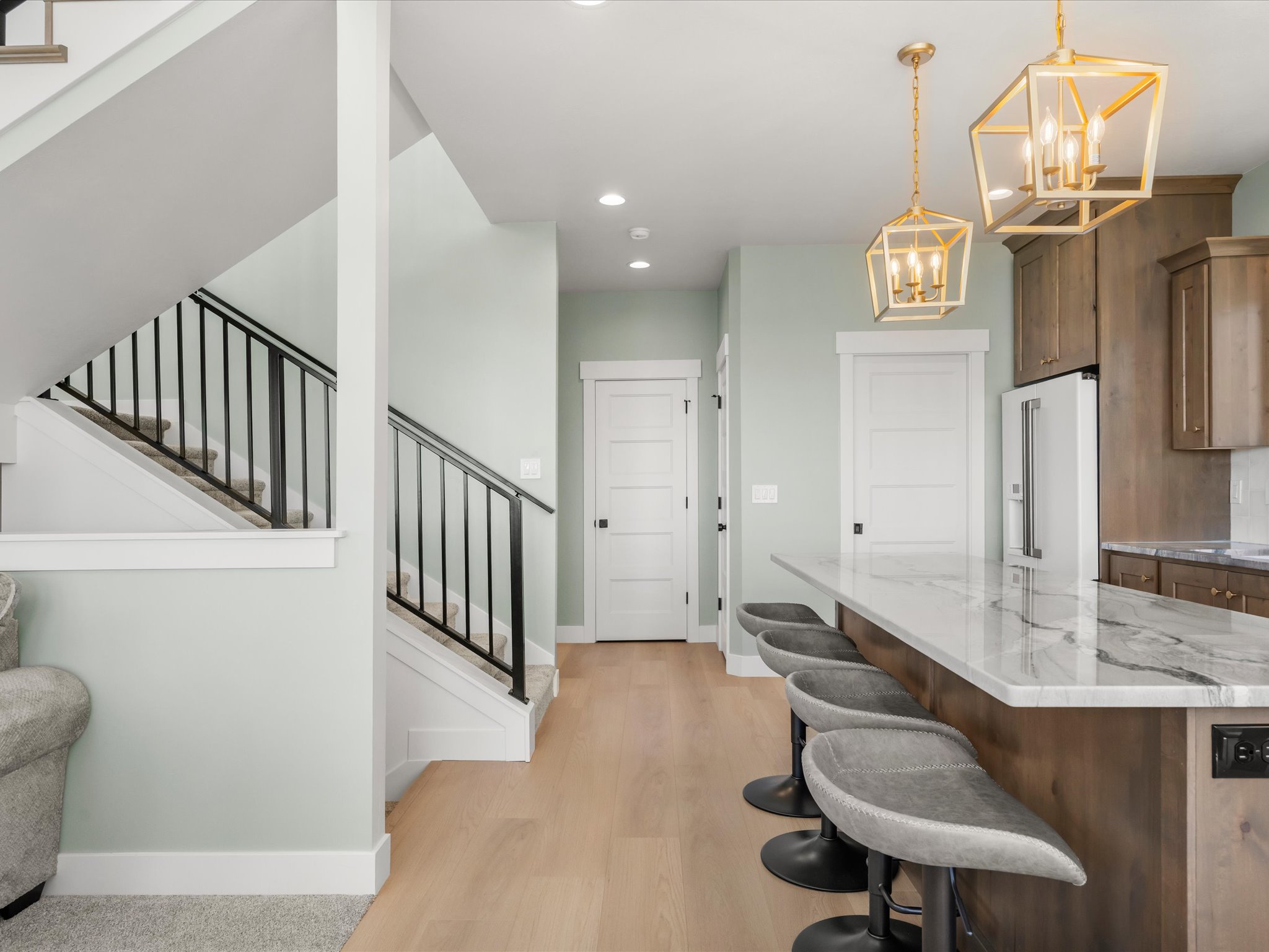Kitchen island featuring a substantial stone-finish countertop and integrated seating