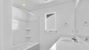 Full bath featuring vanity and shower / washtub combination