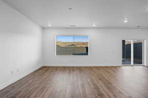 Unfurnished room with dark wood-style floors and recessed lighting