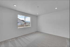 Empty room with carpet flooring and recessed lighting