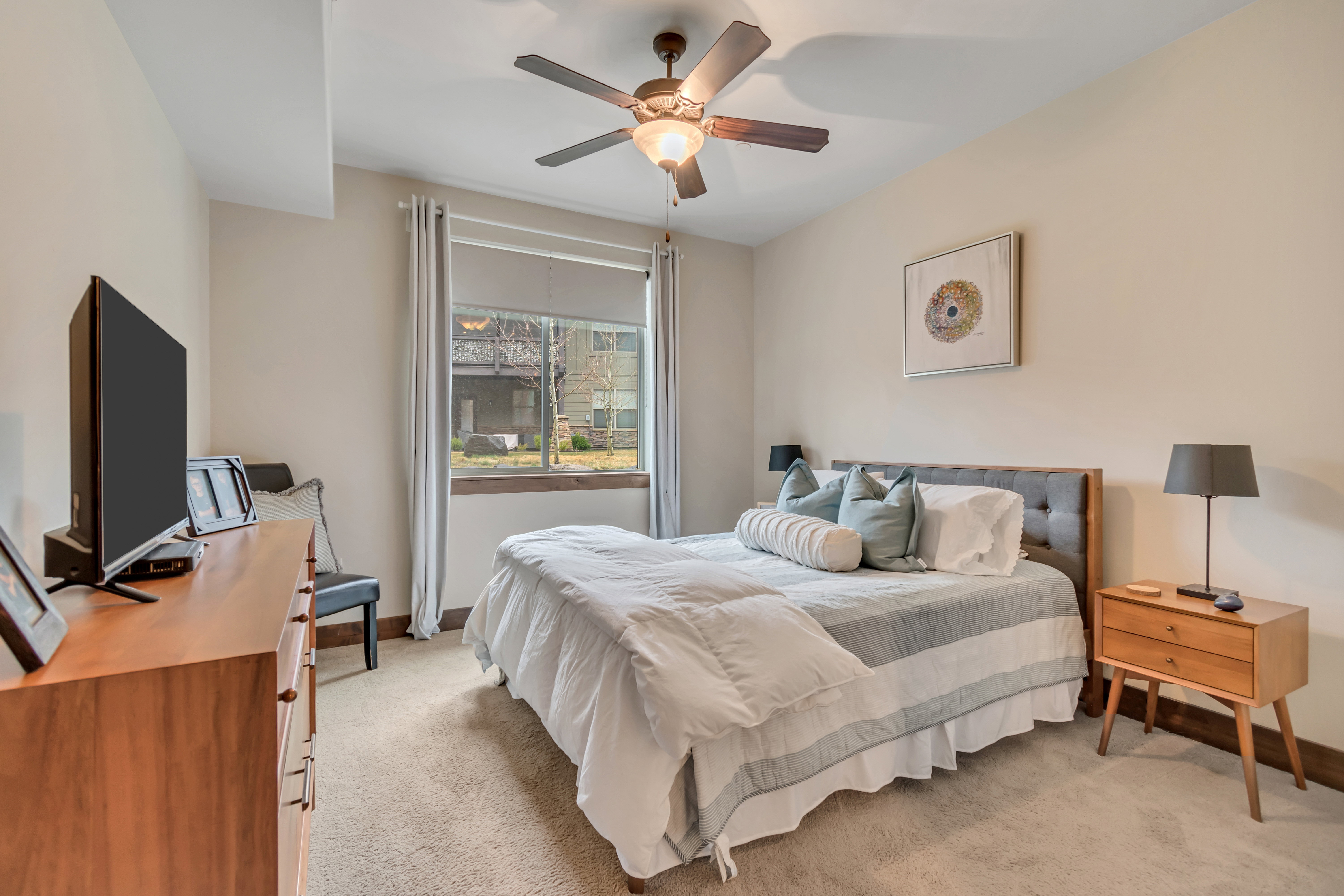 Bedroom featuring light carpet and a ceiling fan