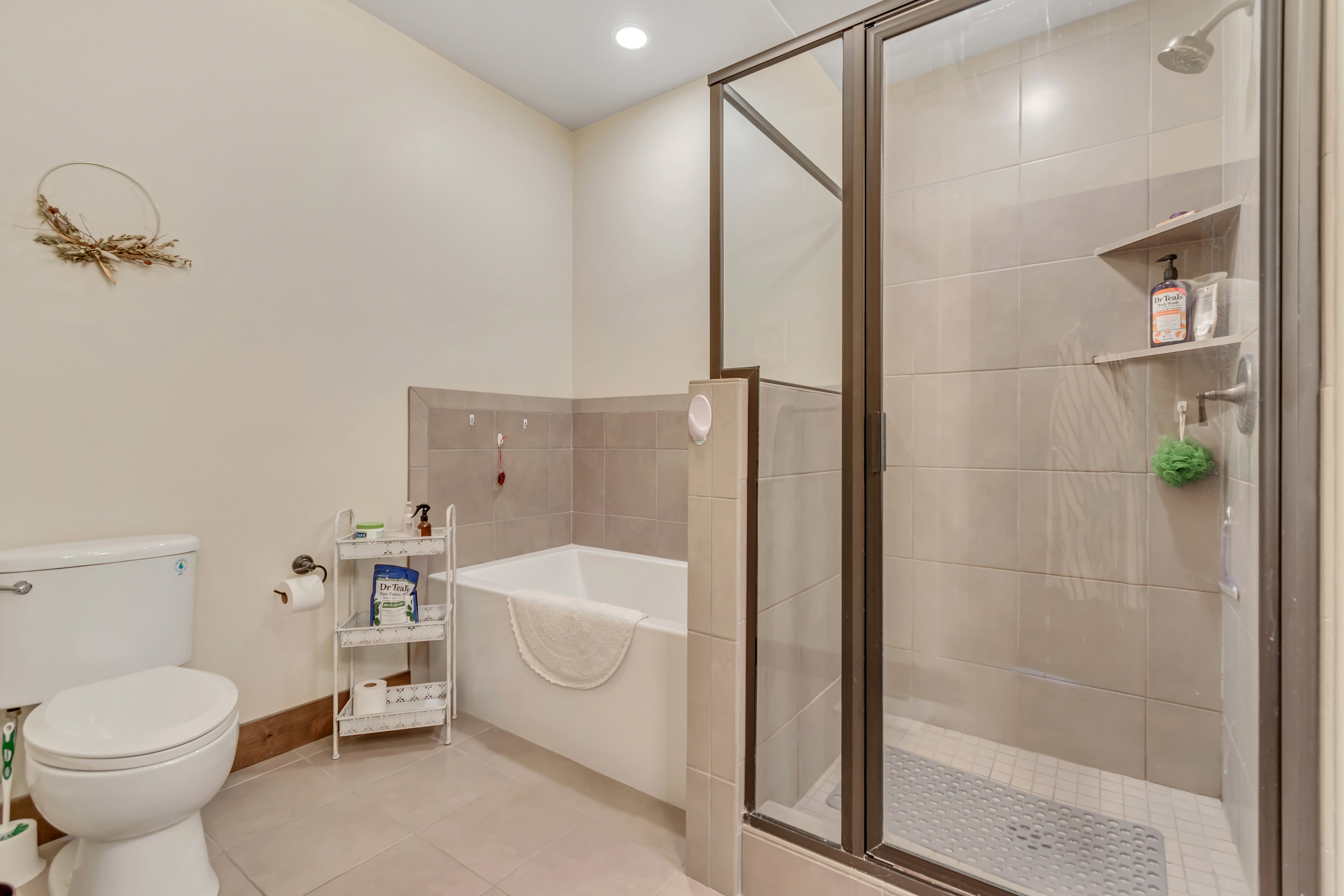 Full bathroom featuring light tile patterned flooring, a stall shower, a garden tub, and recessed lighting