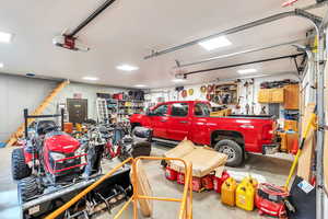 Detached garage featuring a garage door opener, electric panel, heated garage and secure vault.