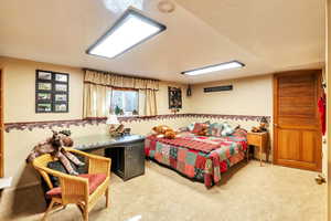 Bedroom featuring light colored carpet