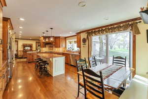 Dining space featuring ornamental molding, light wood-style floors, and recessed lighting