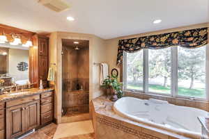 Master Full bath with a tub with jets, vanity, a shower stall, and recessed lighting