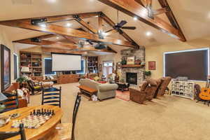 Living area featuring light carpet, built in features, recessed lighting, a fireplace, and ceiling fan