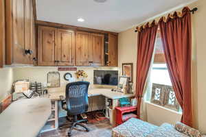 Office area featuring built in desk and recessed lighting