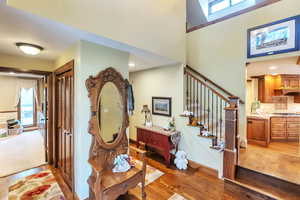 Entrance foyer with light wood-style floors and stairway