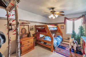 Bedroom featuring a baseboard radiator, light colored carpet, and ceiling fan