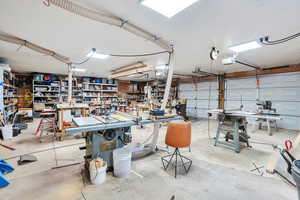 Garage with a workshop area and a garage door opener