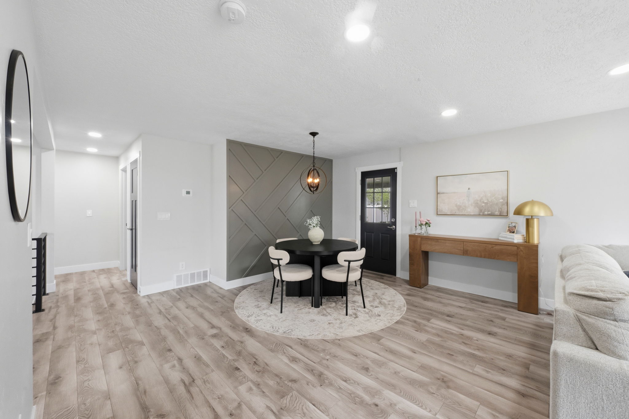 Dining space featuring light wood-style flooring, a textured ceiling, and recessed lighting
