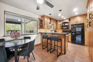 VERY NICE Kitchen with black appliances, a breakfast bar/peninsula, TONS OF NICE Cupboard, with CAN LIGHTING.