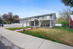 View of front of home with concrete driveway, a garage, and covered porch