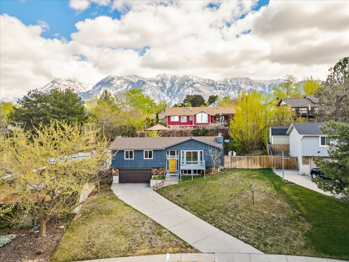 View of front of home with a garage, driveway, and a mountain view