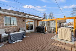 Deck featuring grilling area and shade system