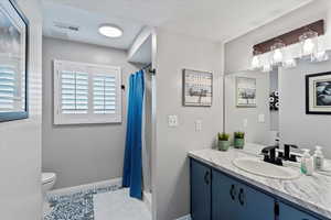 Bathroom featuring vanity, a stall shower, and tile patterned floors