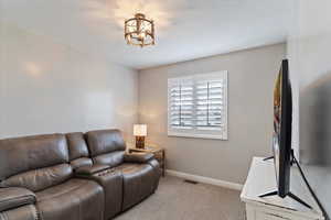 Bedroom with carpet floors and plantation shutters