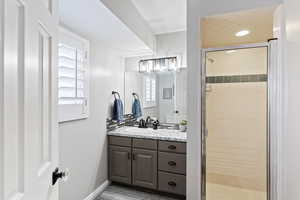 Full bathroom with a stall shower and vanity