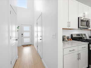 Entry with coat closet and room for bench and hooks.
