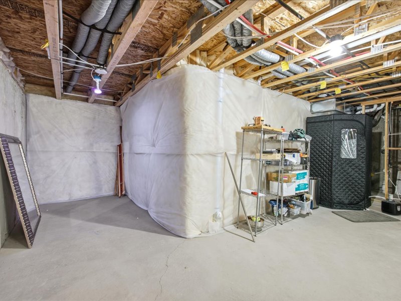 View of unfinished basement plumbed for bathroom