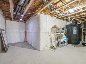 View of unfinished basement plumbed for bathroom