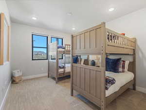 Bedroom with baseboards and light carpet