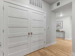Entrance foyer with light wood-style flooring and baseboards